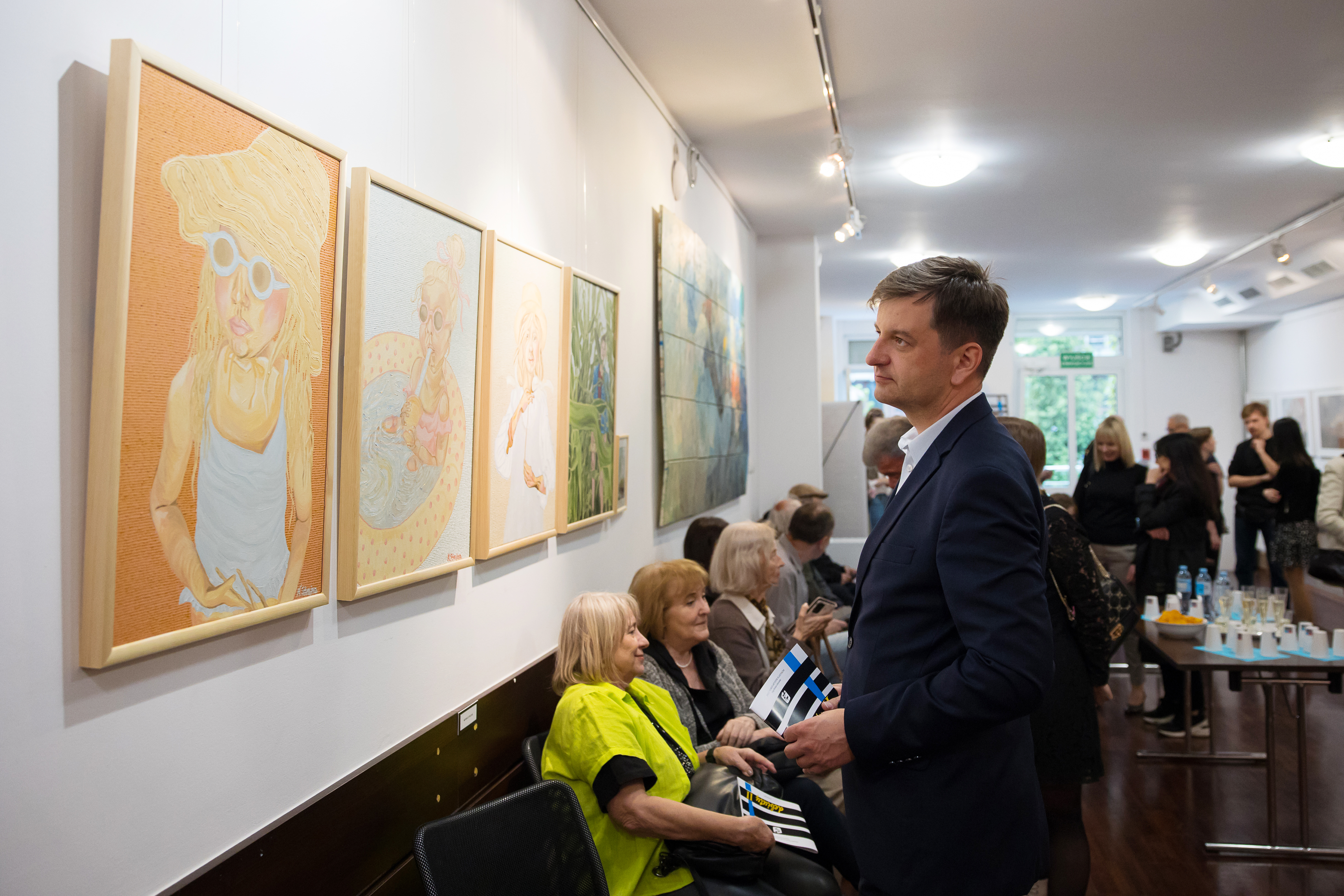Zastępca prezydenta Mariusz Śpiewok ogląda obrazy na wystawie