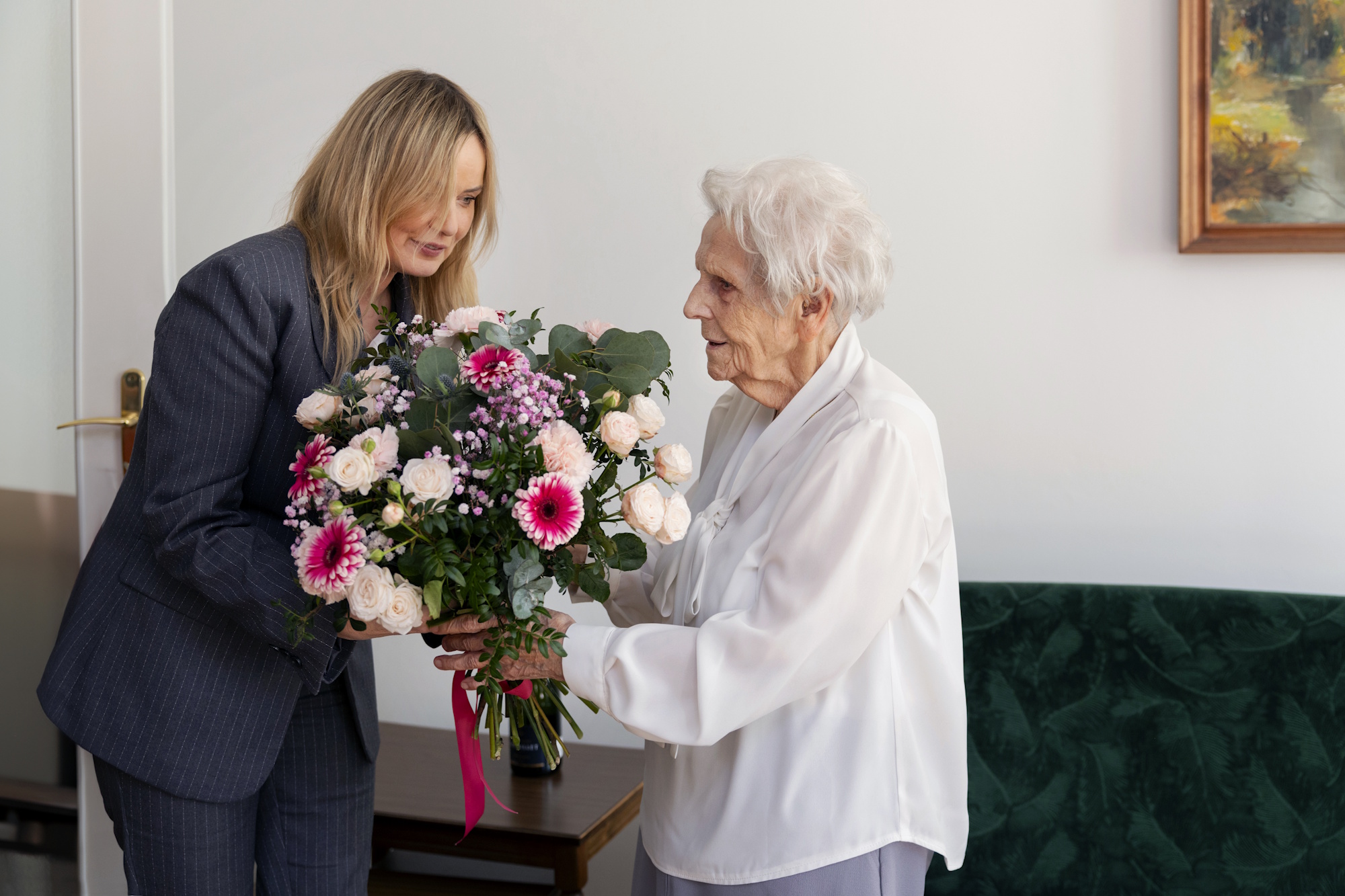 prezydent Gliwic wręcza bukiet kwiatów jubilatce